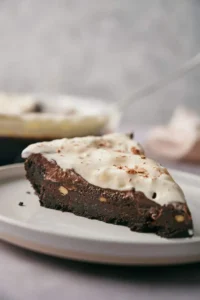 Mississippi mud pie on a plate, ready to eat.