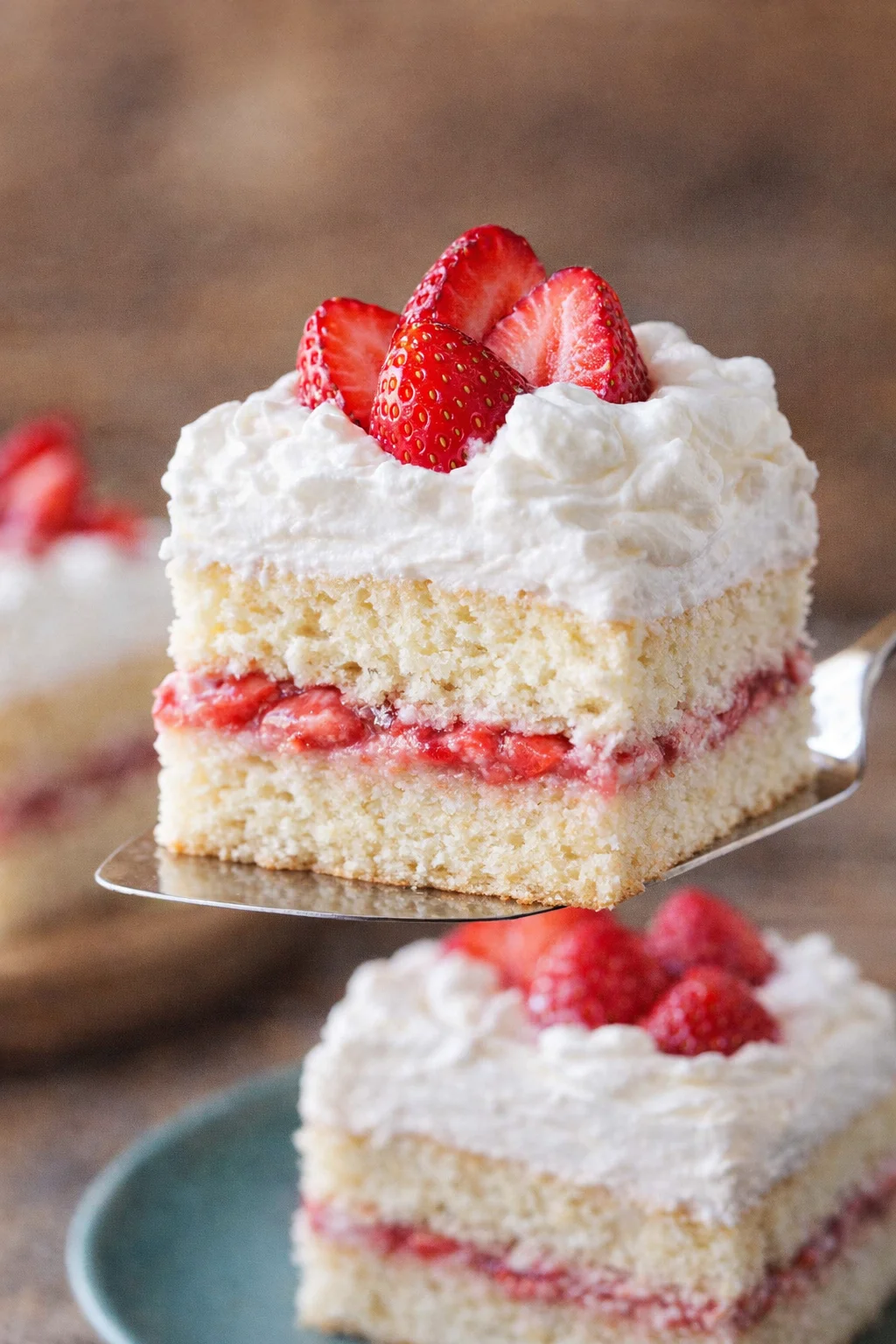 old-fashioned-strawberry-shortcake-slice-cake-server-720x960.jpg Close-up of vanilla shortcake slice with whipped cream and fresh strawberries