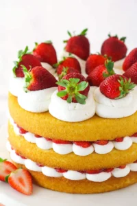 Strawberry shortcake cake on a serving platter.
