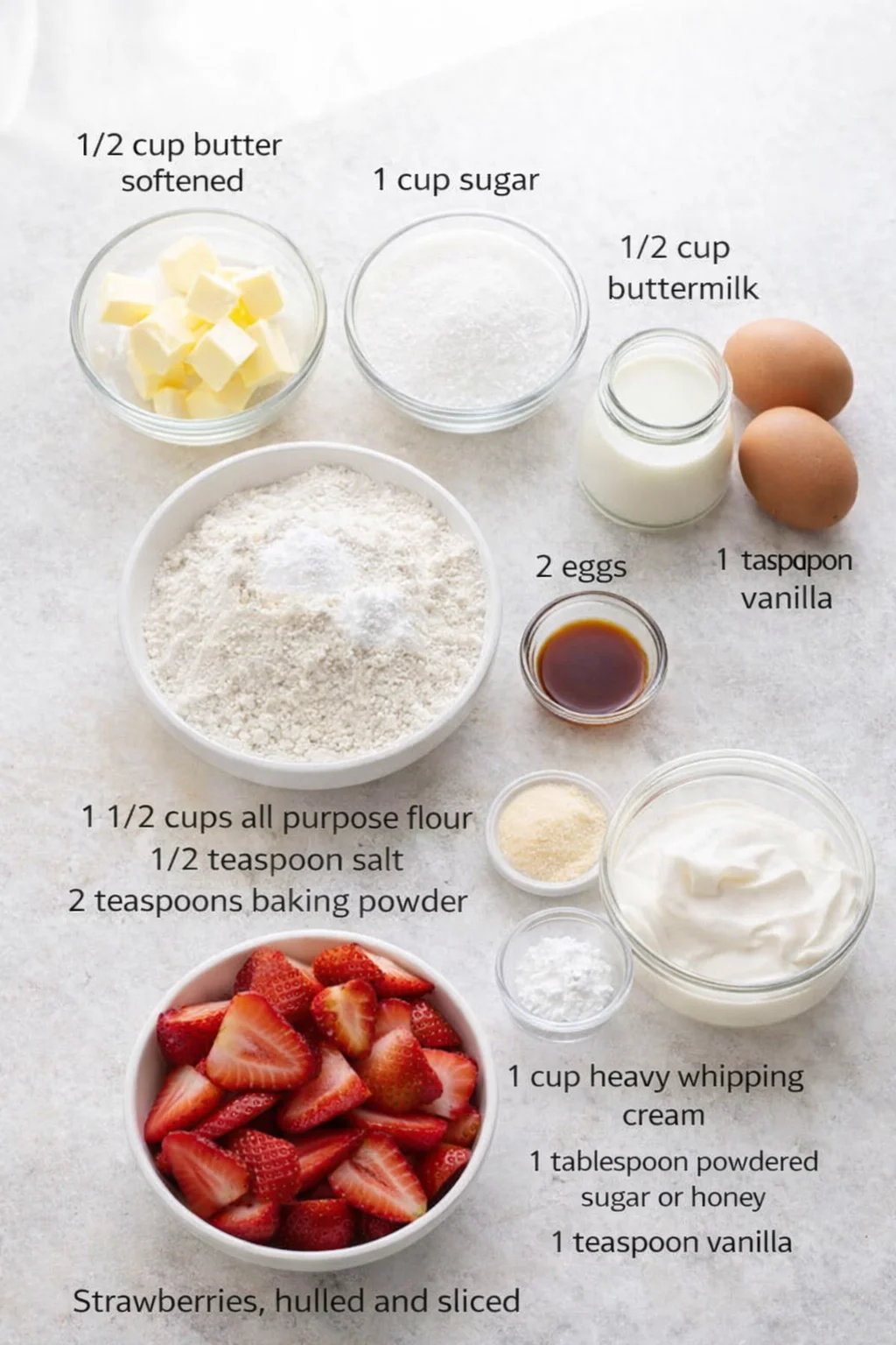 Preparation ingredients for homemade strawberry shortcake with fresh strawberries and whipped cream.