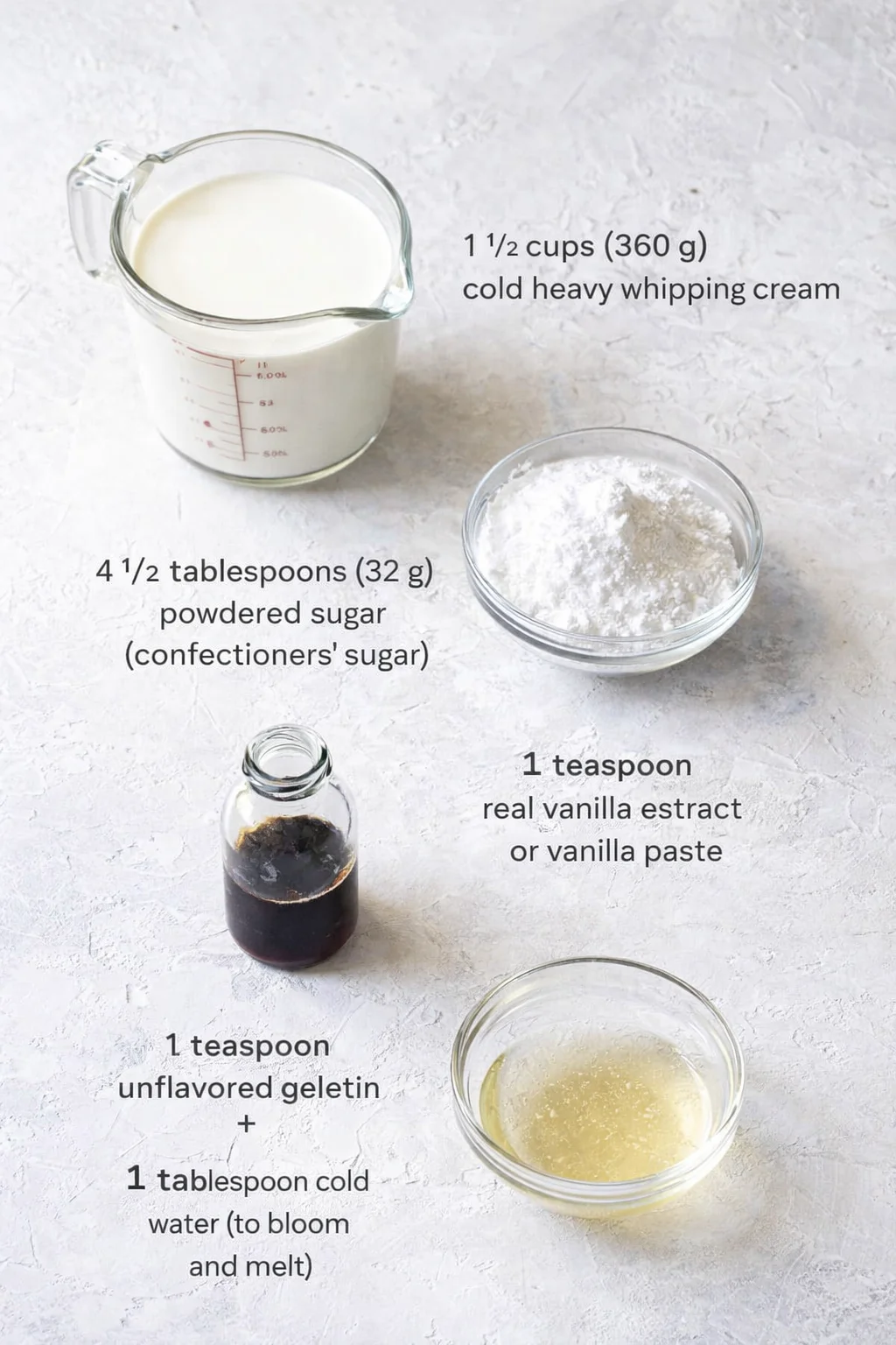 Measured ingredients arranged for How to Make Perfect, Easy Homemade Whipped Cream: 1 1⁄2 cups (360 g) cold heavy whipping cream, 4 1⁄2 tablespoons (32 g) powdered sugar (confectioners’ sugar), 1 teaspoon real vanilla ex