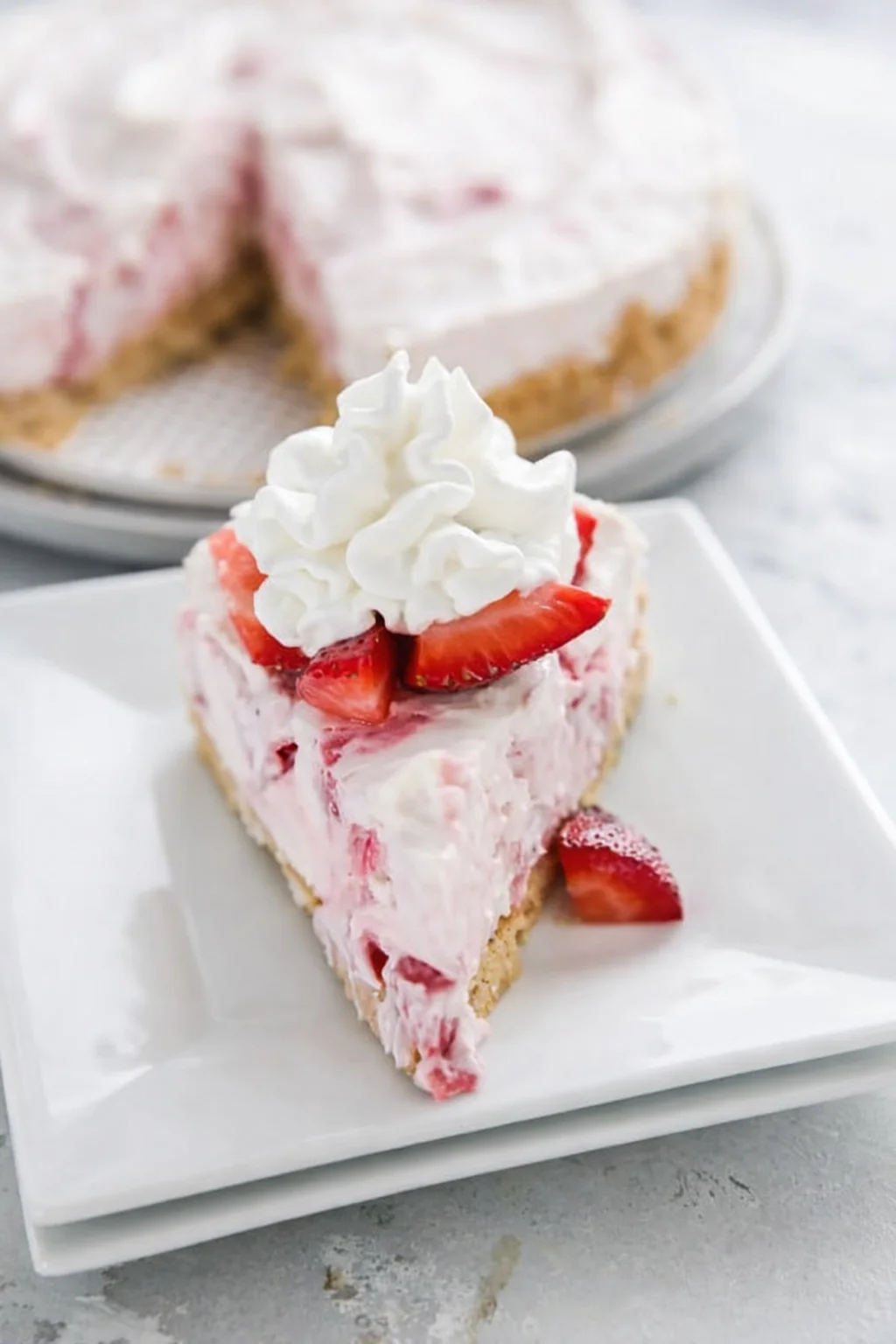 Final plated No-Bake Strawberry Cheesecake served as a hero shot