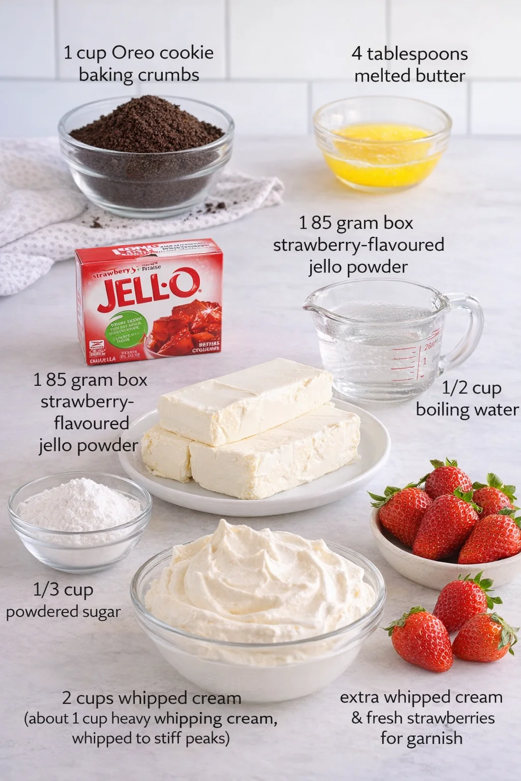 Measured ingredients arranged for Easy No Bake Strawberry Cheesecake: 1 cup Oreo cookie baking crumbs, 4 tablespoons melted butter, 1 85 gram box of strawberry-flavoured Jello powder, 1/2 cup boiling water, 800 grams ful