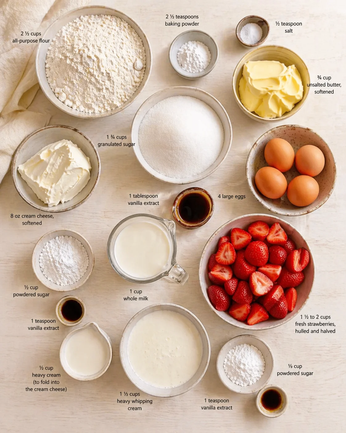 Top-down view of baking ingredients arranged in bowls on a light wooden surface.