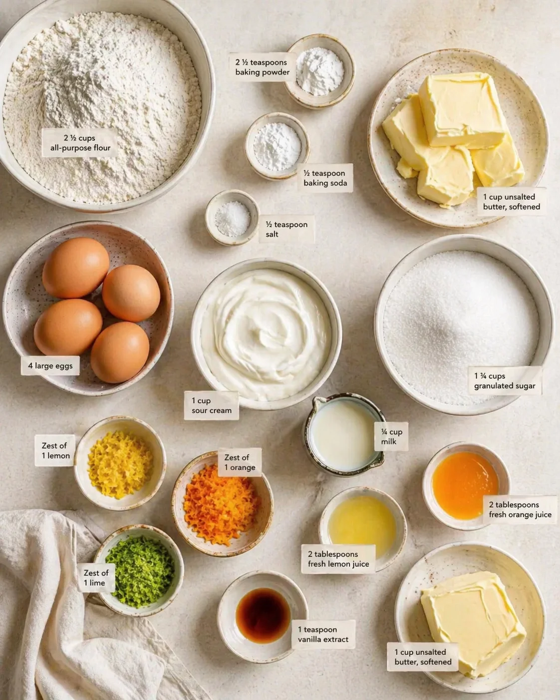 top-down view of baking ingredients arranged with labeled measurements on a light counter