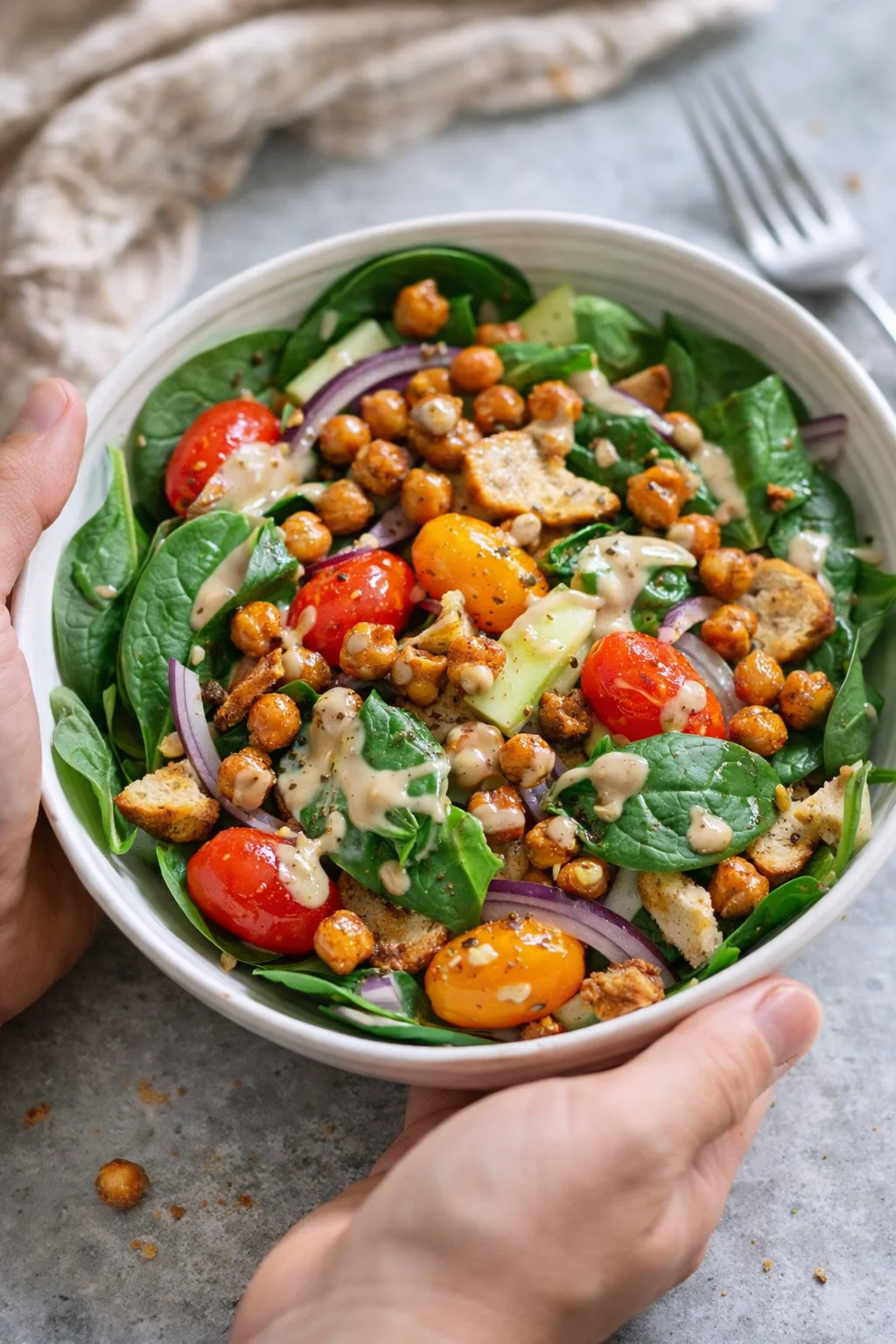 Single plated variation of Easy Vegan Spinach Salad Recipe shown in a natural kitchen scene
