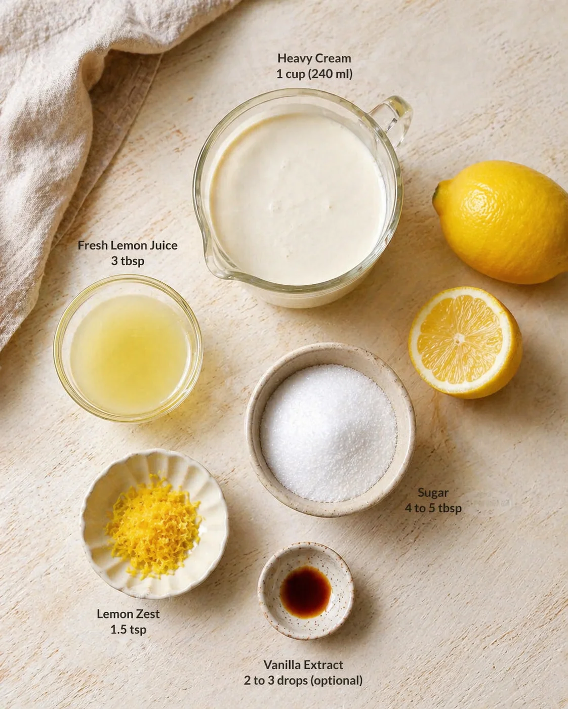 top-down view of lemon, juice, sugar, zest, vanilla, and cream ingredients on a wooden surface