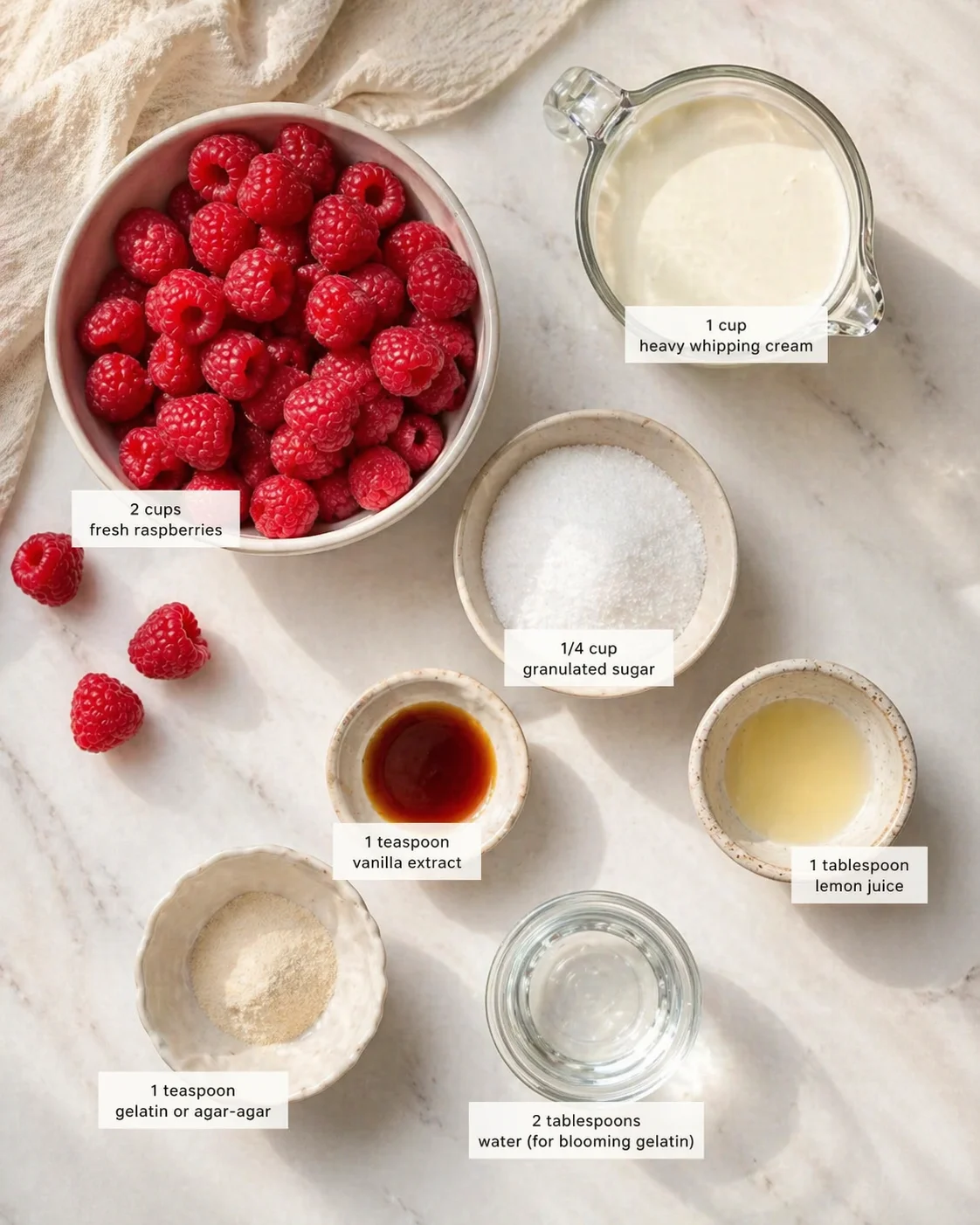 Overhead view of raspberries with cream, sugar, vanilla, lemon juice, gelatin or agar-agar, and water.