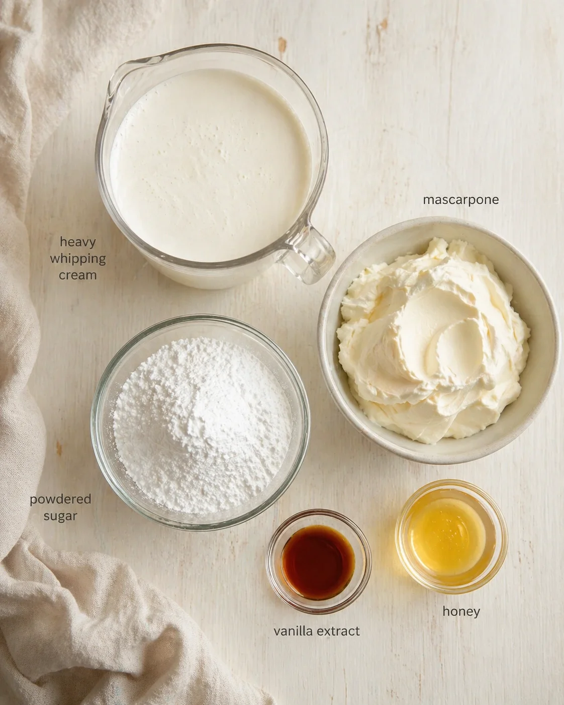 flat lay of ingredients for vanilla mascarpone cream on a light wooden surface