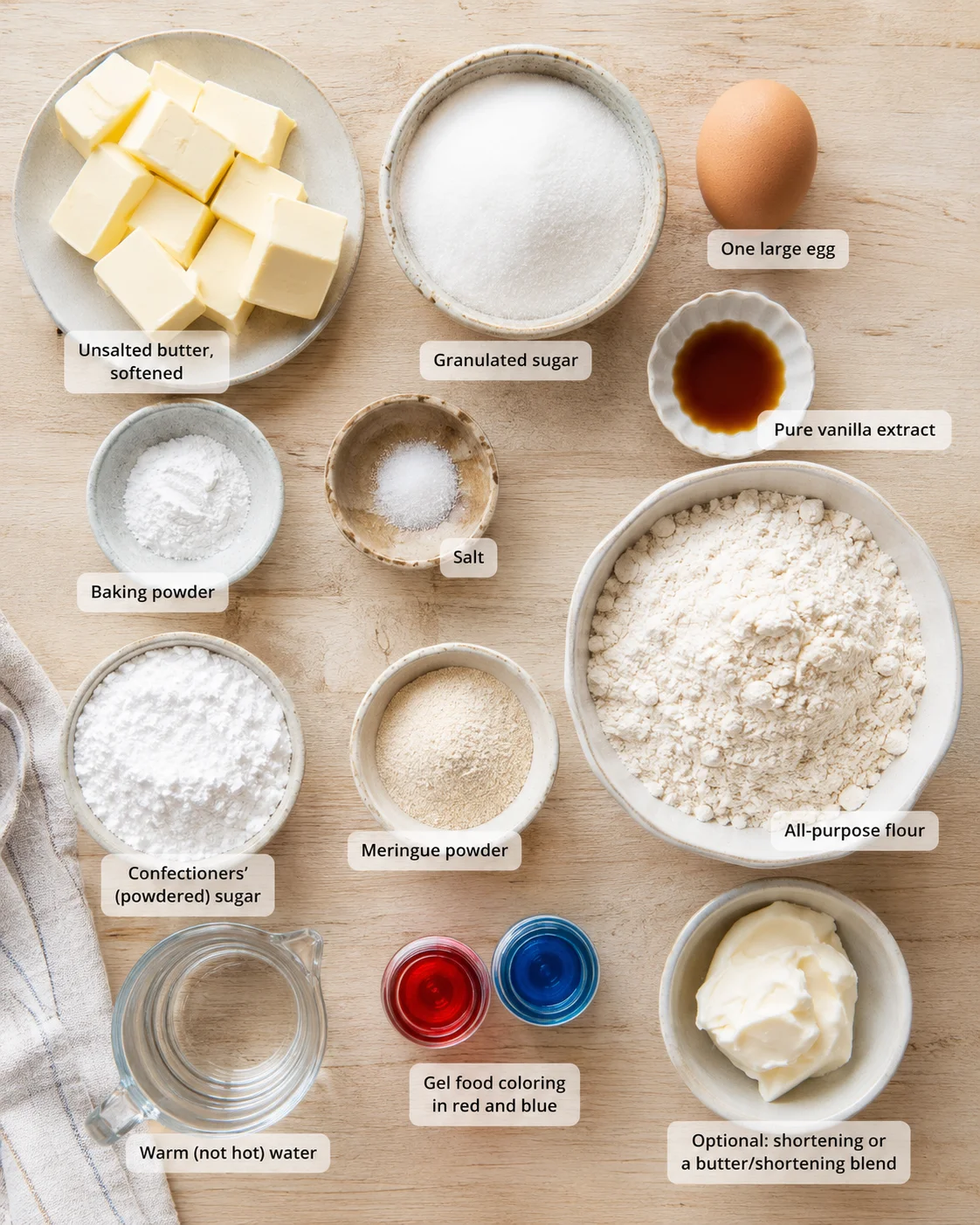 Top-down view of baking ingredients laid out with labeled bowls on wood.
