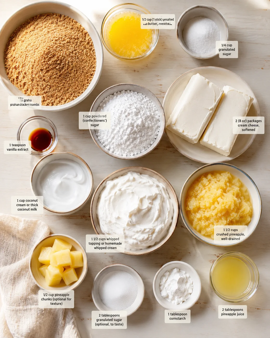 Overhead shot of ingredients for pineapple-coconut cheesecake arranged with measurement tags.