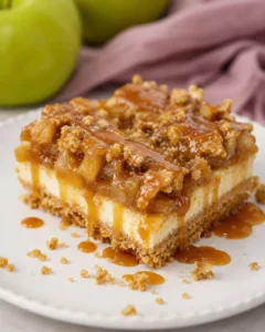 Delicious layered caramel apple cheesecake bars topped with streusel and caramel drizzle.
