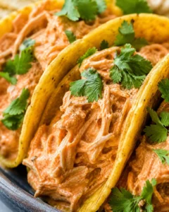 Delicious pulled chicken tacos topped with cilantro and salsa in soft tacos.