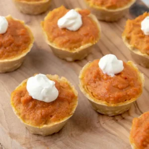 Homemade pumpkin pie for dogs on a wood board.