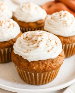 Close-up of moist, fluffy pumpkin cupcakes with dairy-free cream cheese frosting.