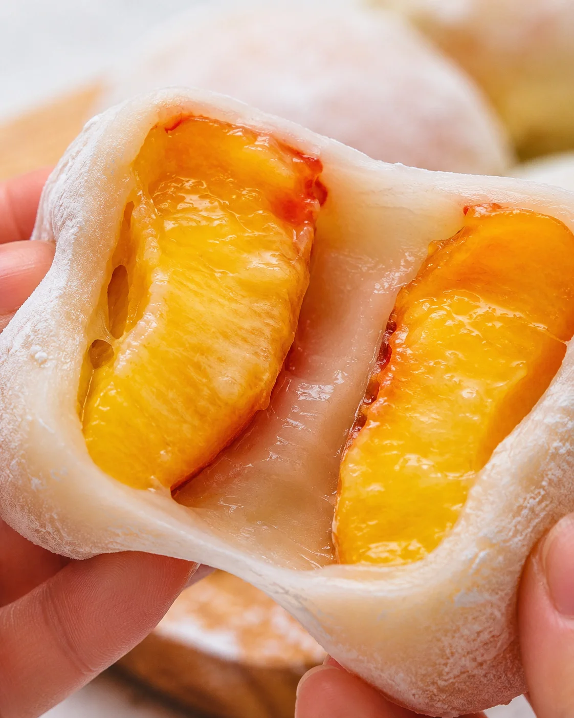 Close-up of juicy peach mochi with ripe peach filling inside