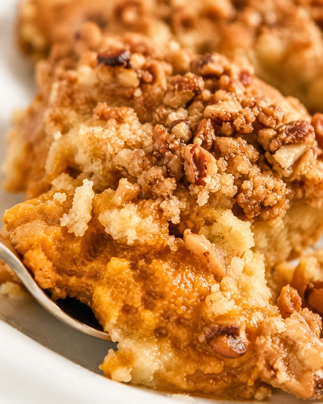 Close-up of a freshly baked pumpkin dump cake with crunchy nut topping