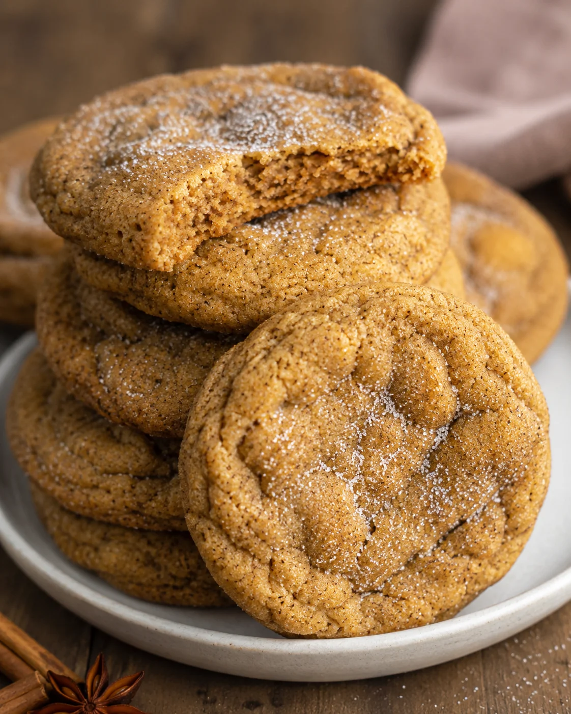 Stack of freshly baked chewy pumpkin cookies with sugar topping.