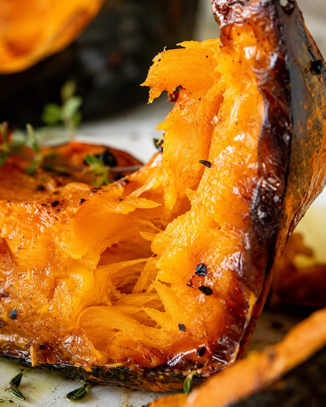 Golden roasted pumpkin wedges seasoned with herbs and spices, perfect for fall meals.