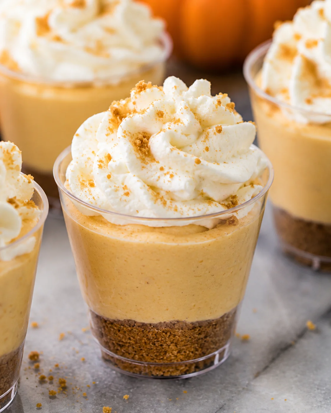 Delicious no-bake mini pumpkin pie cheesecakes with whipped cream topping