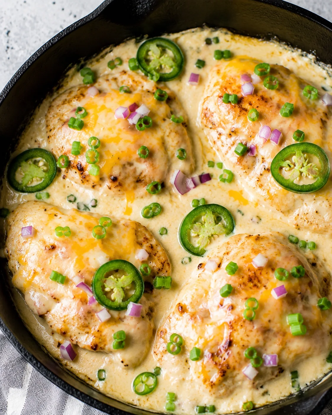 Creamy, cheesy keto chicken skillet with jalapenos and green onions