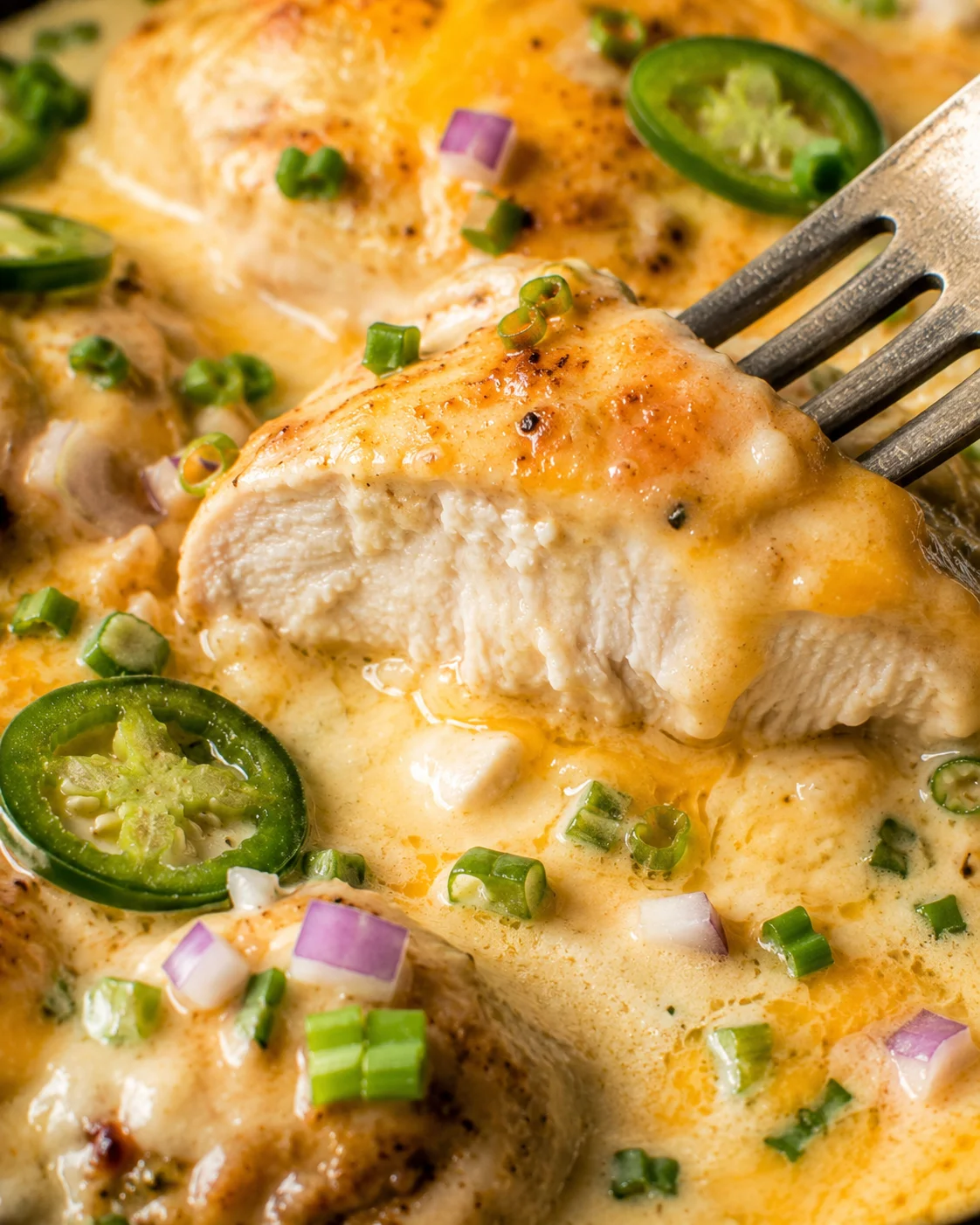 Creamy, cheesy jalapeno chicken dish topped with green onions and jalapenos