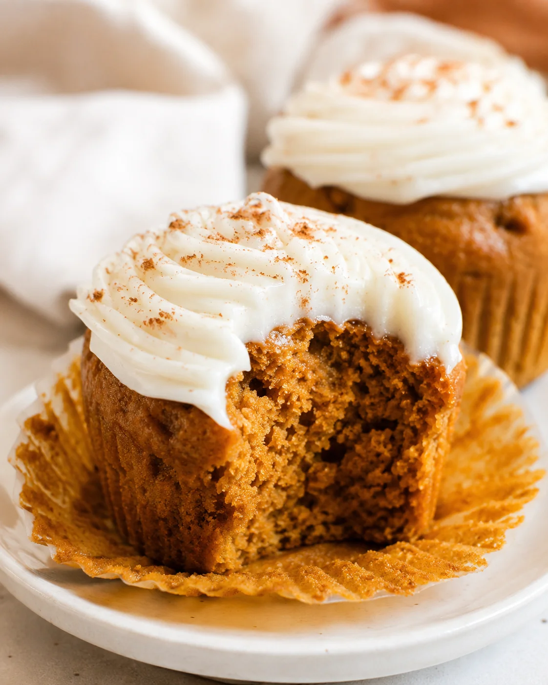 Delicious moist pumpkin cupcakes topped with creamy dairy-free frosting.