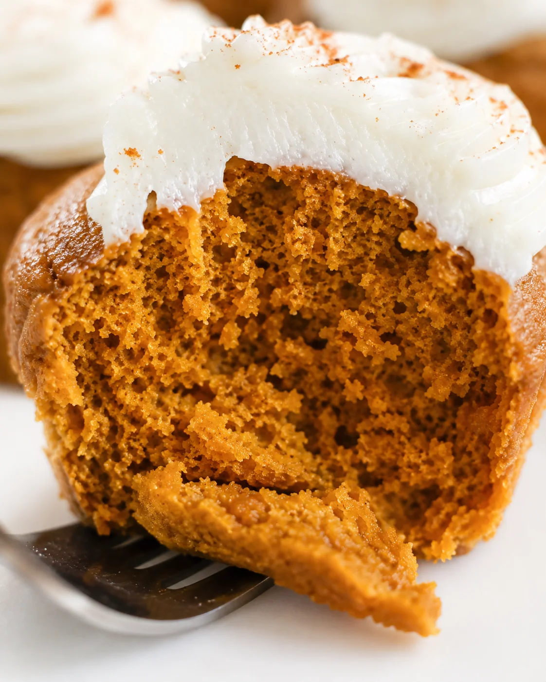 Moist, fluffy pumpkin cupcakes topped with dairy-free cream cheese frosting.