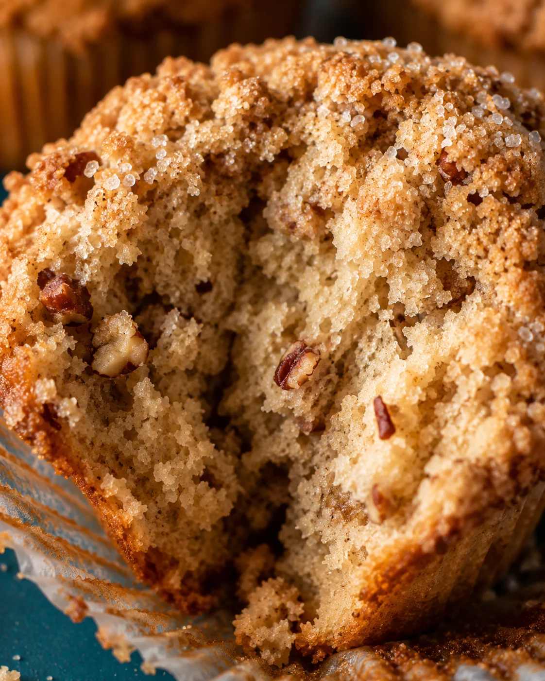 Close-up of a moist, crunchy maple pecan muffin with a soft interior.