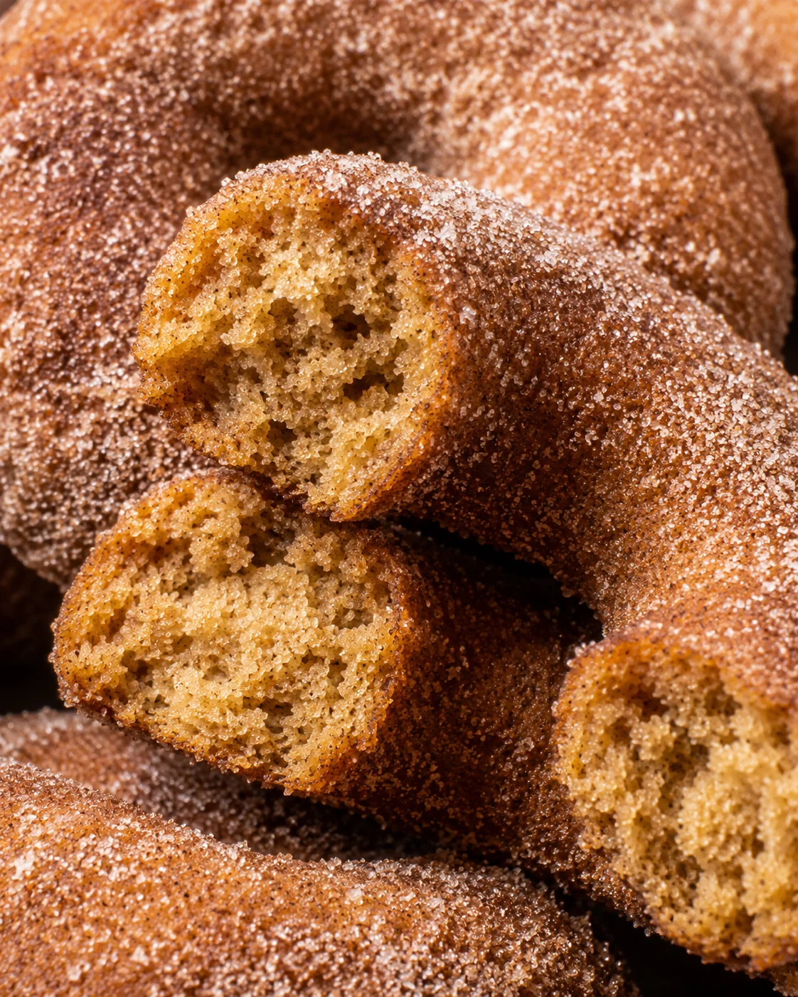 Close-up of freshly baked apple cider donuts with cinnamon sugar crusts