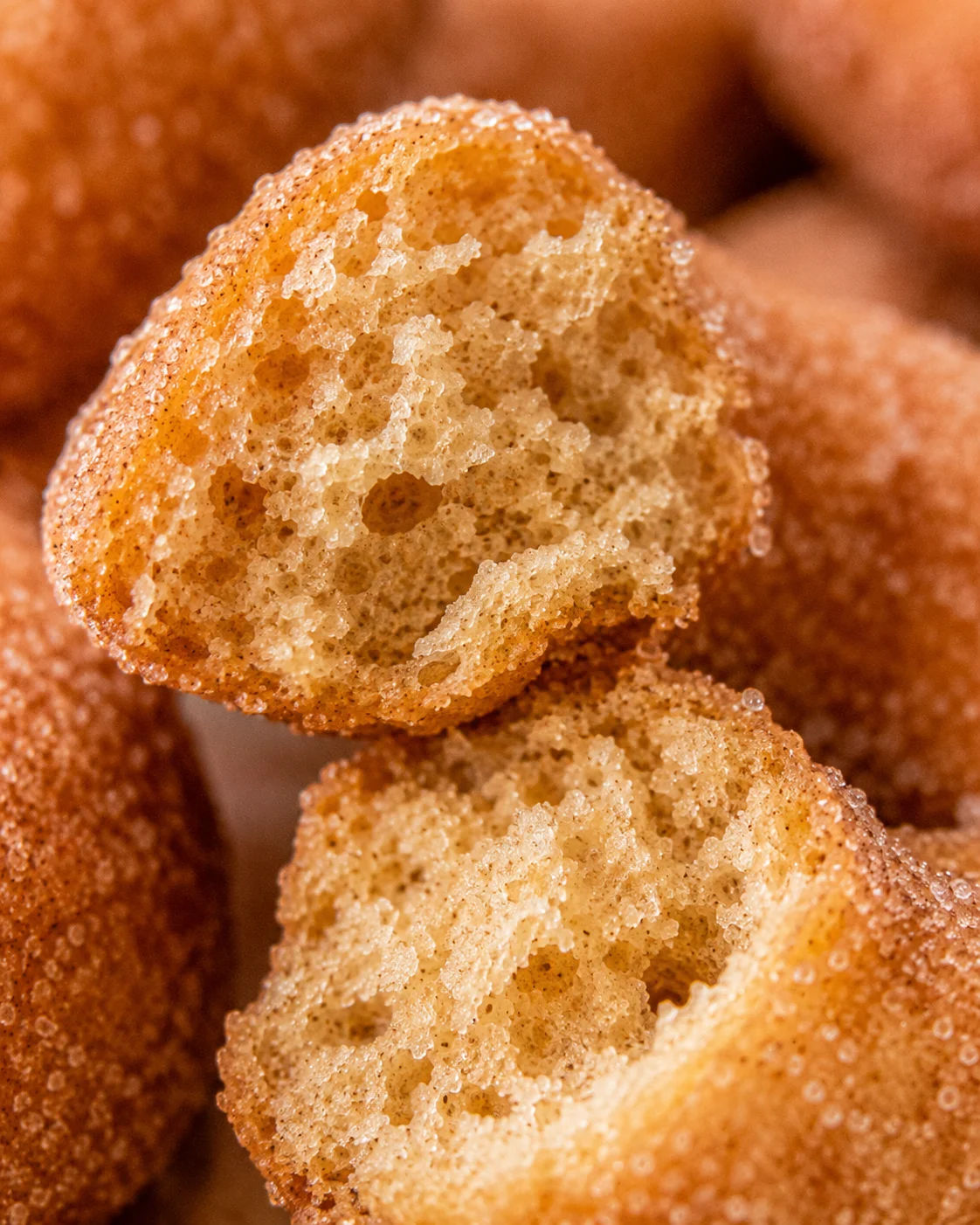 Close-up of soft, moist baked apple cider donuts with cinnamon sugar coating.