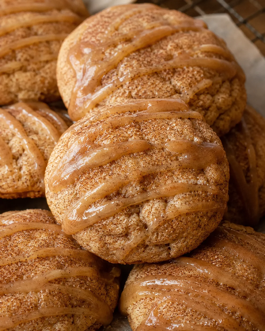 Close-up of soft, cinnamon-sugar coated apple butter snickerdoodles drizzled with glaze