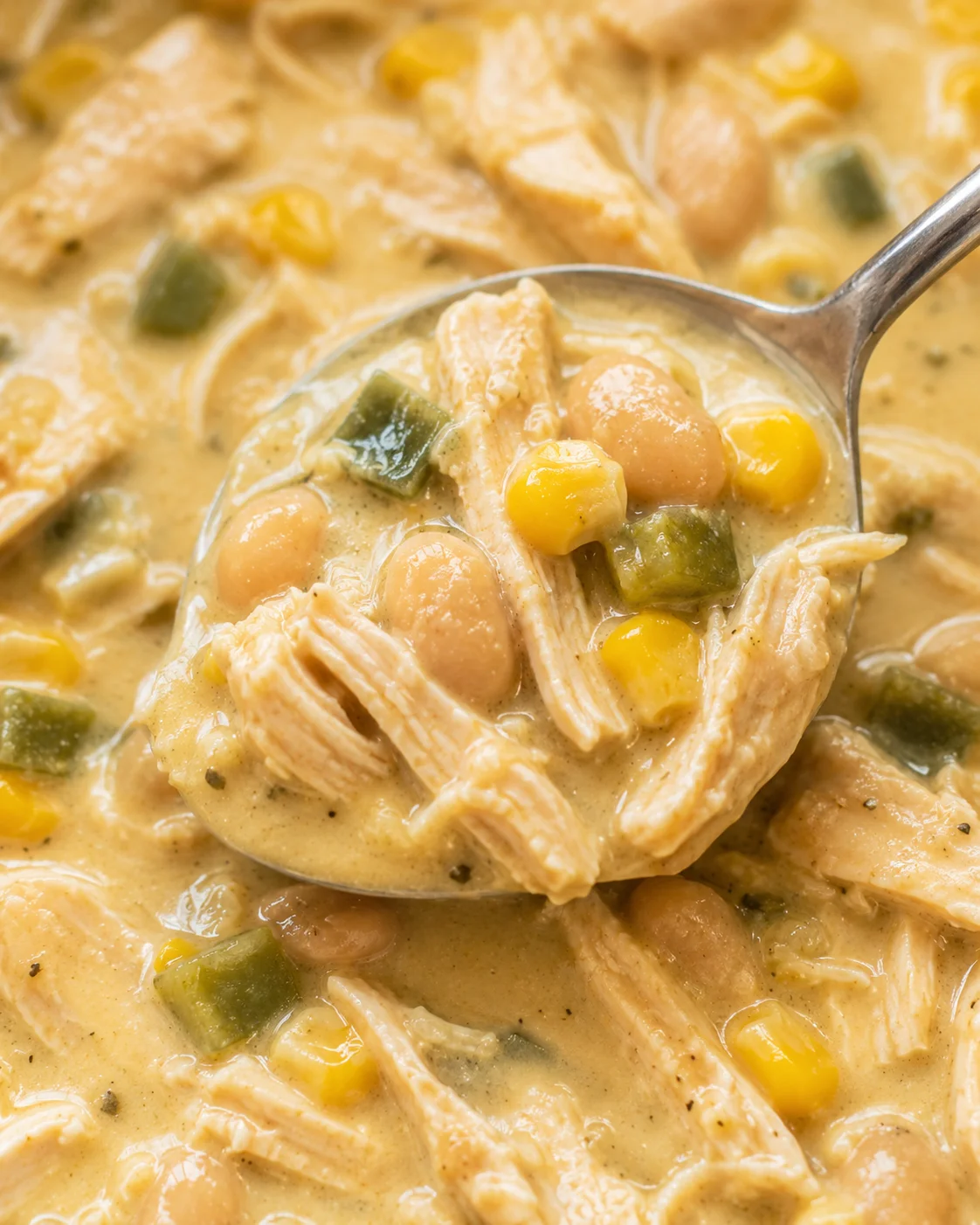 Close-up of a creamy, comforting white chicken chili with corn and beans