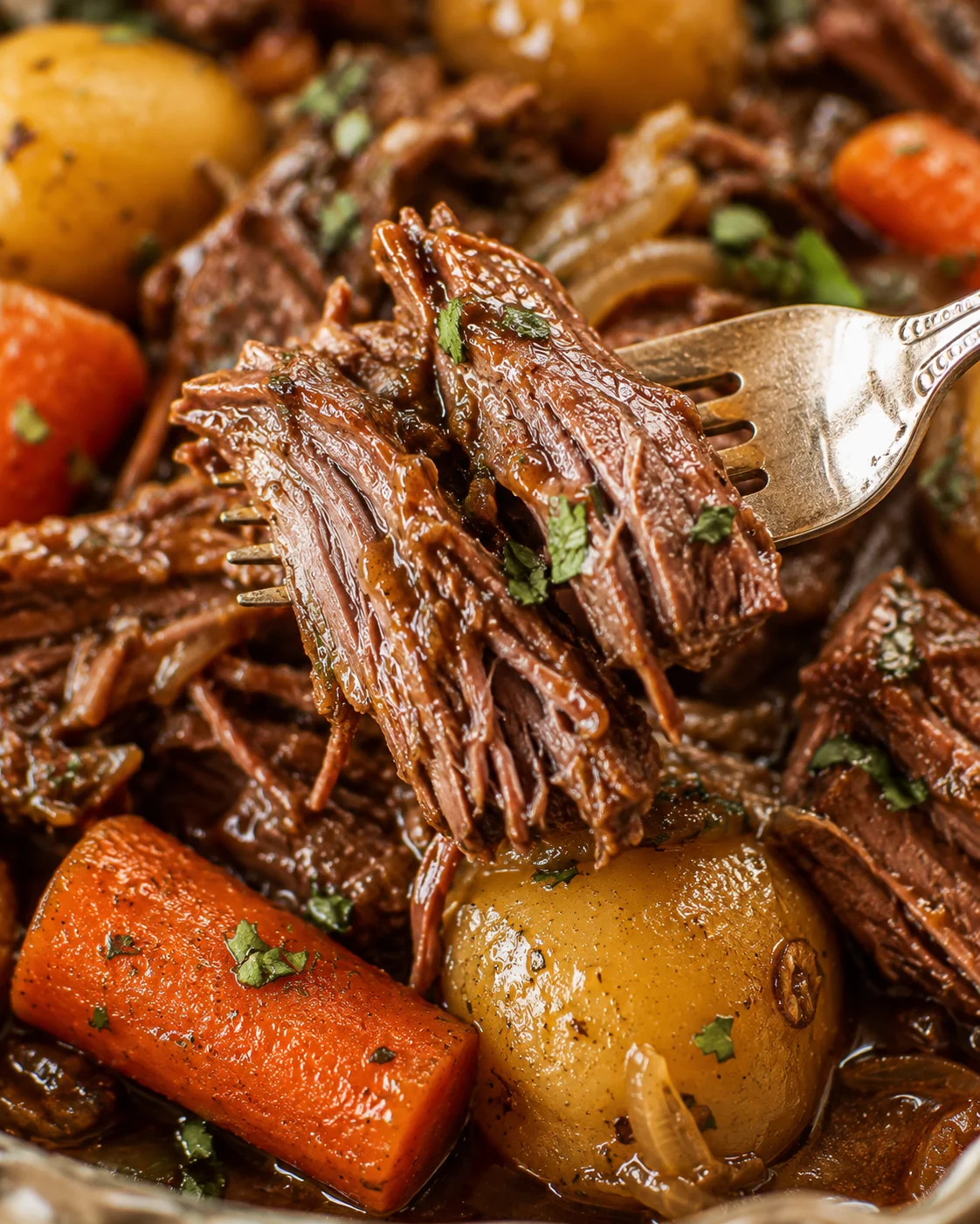 Tender, juicy chuck roast cooked with carrots, potatoes, and onions in a slow cooker.