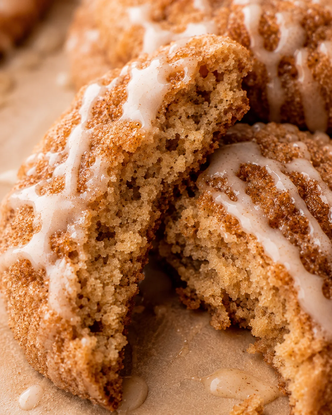 Close-up of soft apple cider cookies with cinnamon sugar and glaze drizzles