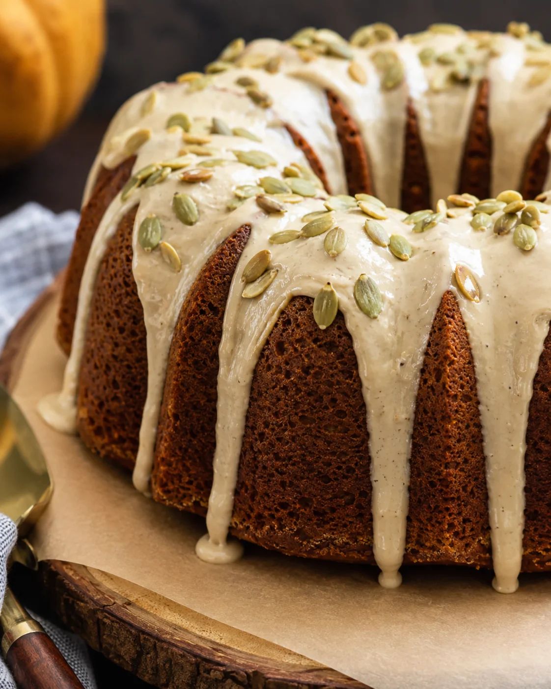 A moist pumpkin bundt cake topped with a rich maple brown-butter glaze and pumpkin seeds