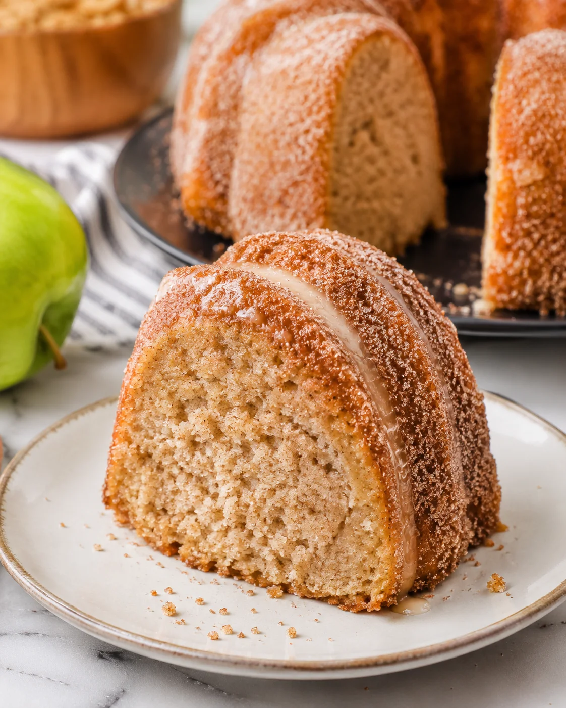 Delicious apple cider donut cake with warm spices and a sweet glaze.